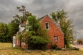 Abandoned old brick house on the grassy field Royalty Free Stock Photo