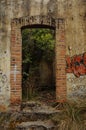 Abandoned old brick wall with graffiti