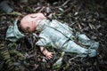 Abandoned old broken baby doll rots in scary forest