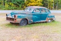 Abandoned old car decaying in the middle of a meadow Royalty Free Stock Photo