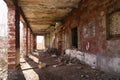 Abandoned old factory with brick columns and debris