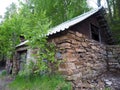 Abandoned old half-ruined stone house amidst forest Royalty Free Stock Photo