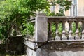 Decrepit balustrade of an old abandoned mansion in the garden