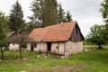 Abandoned old rural house with red rood. Village house