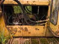 Abandoned old rusty bulldozer with diesel motor and hydraulic hose, vintage industrial heavy machine, earthmover equipment,