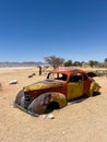 Abandoned old rusty car. Body of a retro car in the sands. Desert in Namibia. Royalty Free Stock Photo