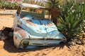 Abandoned old rusty cars in the desert of Namibia surrounded by cactus near the Namib-Naukluft National Park