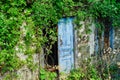 Faded Blue Doors on Abandoned Stone House, Greece