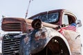 Abandoned old truck with american flag on the roof. Royalty Free Stock Photo