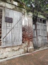 Abandoned old wooden door set against exposed brick wall