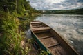 abandoned old wooden fishing boat near pier in summer lake or river. beautiful summer sunny day or evening Royalty Free Stock Photo