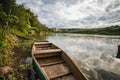 abandoned old wooden fishing boat near pier in summer lake or river. beautiful summer sunny day or evening Royalty Free Stock Photo
