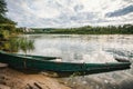 abandoned old wooden fishing boat near pier in summer lake or river. beautiful summer sunny day or evening Royalty Free Stock Photo