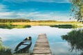 Abandoned Old Wooden Fishing Boat Near Pier In Summer Lake Or River. Beautiful Summer Sunny Day Or Evening. Forsaken Royalty Free Stock Photo