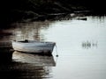 Abandoned old wooden rowing boat near riverbank, wintry weather. Royalty Free Stock Photo