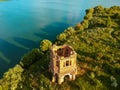 Abandoned Orthodox church on lake shore from drone Royalty Free Stock Photo