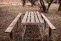 Abandoned outdoor wooden table  and chairs Royalty Free Stock Photo