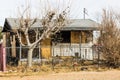 Abandoned Overgrown Home With Boarded Up Windows & Door