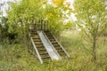 Abandoned overgrown wooden slide