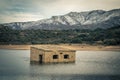 Abandoned and partially submerged stone building in lake in Corsica