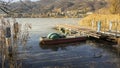 Abandoned pedal boats at the pier in the reeds on the shore of the lake. Autumn season Royalty Free Stock Photo