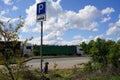 Abandoned pet dog leashed on parking sign pole