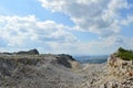 Abandoned place with quarry stones under cloudy sky