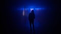 Portrait of female in the dark hallway with neon light. Woman with flashlight walking down the corridor with door and