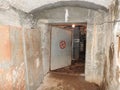 An abandoned prison in an underground bunker. A former Soviet cold war bomb shelter. The sealed door of the bunker. Pipes and