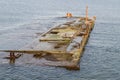 Abandoned quay submerged in water