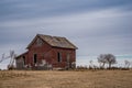 An abandoned red brick farmhouse near Coderre, Saskatchewan