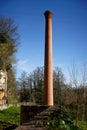 Abandoned red brick industrial chimney in nature Royalty Free Stock Photo