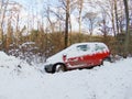 Abandoned red car forest in snow crashed ditched hazard left behind vehicle