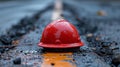 Abandoned Red Hard Hat on Road Royalty Free Stock Photo