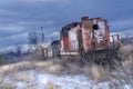 Red abandoned train locomotive in winter with snow