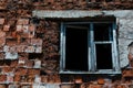 Abandoned redbrick building. Close-up of wooden window.