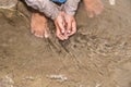 Abandoned refugee boy drinking water from river and clothes are dirty and his eyes are full of pain Royalty Free Stock Photo