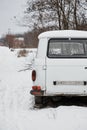 Abandoned retro car Barkas-Werke, back view in the forest in winter Royalty Free Stock Photo