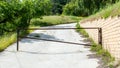 Abandoned road blocked by a metal gate