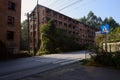 Abandoned roadside red-brick multi-storied apartment of 1970s