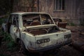 Abandoned and robbed old cars standing in the open air