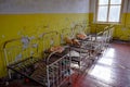 An abandoned room with rusted metal bed frames. Old children\'s beds in an abandoned kindergarten. The interior of a room