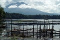 Abandoned Rotting bamboo fish cages along mountain lake