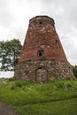 Abandoned ruin of old windmill tower near the city.