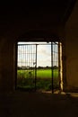 Abandoned Ruin in Southern Italy with Open Gate and Scenic Italian Landscape Beyond Royalty Free Stock Photo