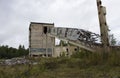 abandoned ruined building. concrete walls with broken windows and a lift, industrial buildings. victory of nature over Royalty Free Stock Photo