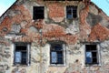 Abandoned ruined house closeup of broken windows and fallen facade Royalty Free Stock Photo