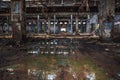 Abandoned ruined industrial warehouse or factory building inside, corridor view with perspective, ruins and demolition concept Royalty Free Stock Photo