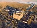 Abandoned and ruined Nuclear Power Plant in Shelkino, Crimea. Industrial construction with round tower of atomic reactor