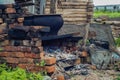 Abandoned ruined old house, hut. In the middle stands a stove. The fallen roof.